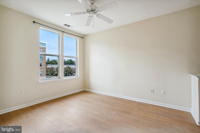 empty room with ceiling fan and light wood-type flooring