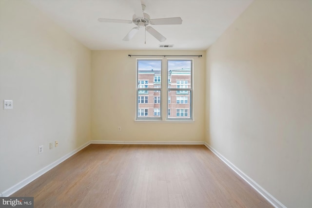 empty room with light hardwood / wood-style flooring and ceiling fan