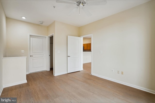 unfurnished bedroom with ceiling fan and light hardwood / wood-style flooring