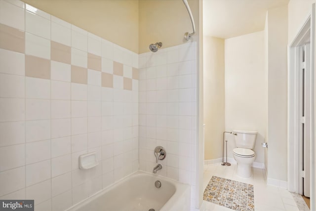 bathroom with tile patterned floors, toilet, and tiled shower / bath