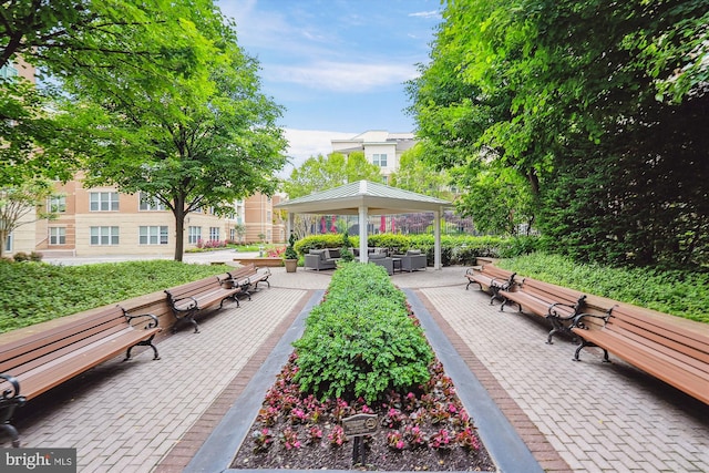 view of property's community with a gazebo, an outdoor living space, and a patio area