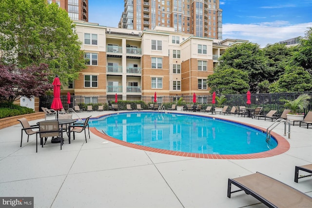 view of swimming pool with a patio