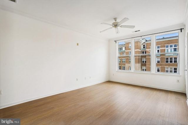 unfurnished room featuring crown molding, ceiling fan, and hardwood / wood-style flooring