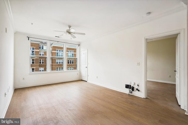 empty room with hardwood / wood-style flooring, ceiling fan, and ornamental molding