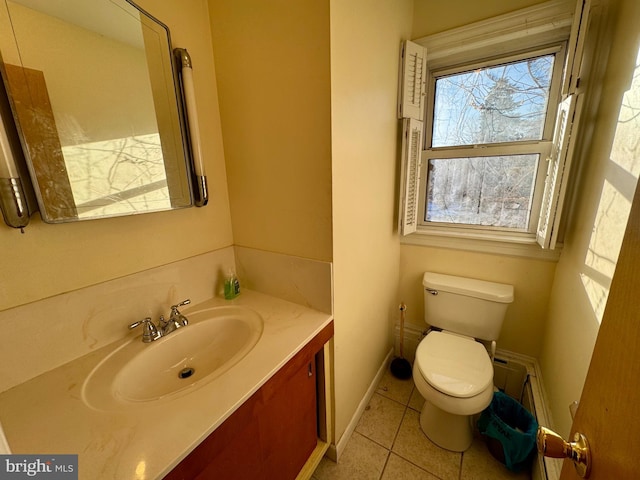 bathroom featuring vanity, tile patterned floors, and toilet