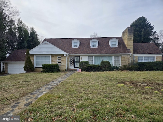 view of front facade with a garage and a front lawn