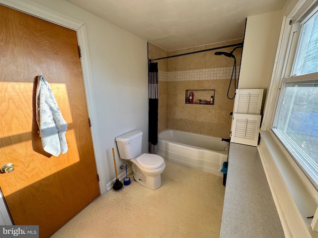 bathroom with shower / tub combo with curtain and toilet