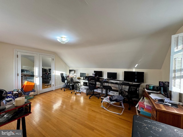 home office featuring vaulted ceiling and light hardwood / wood-style floors