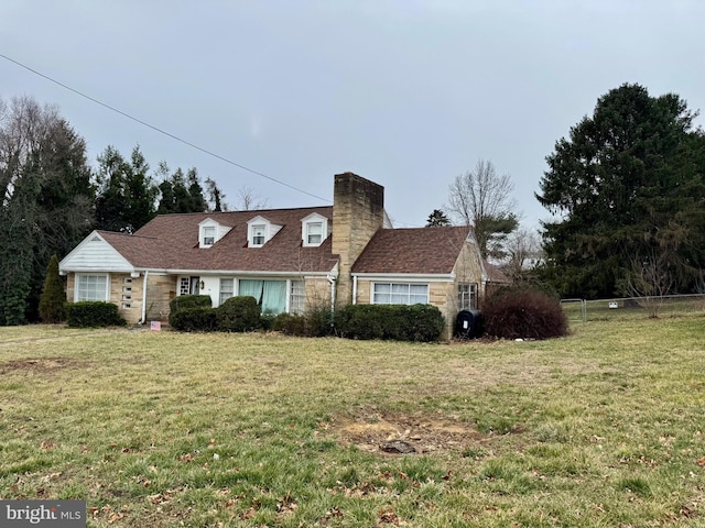 cape cod home with a front lawn