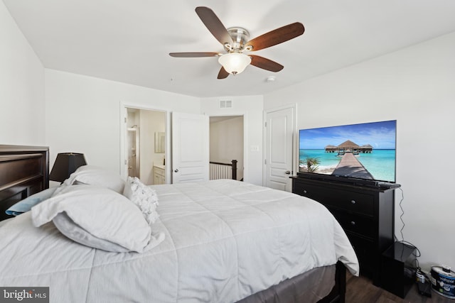 bedroom featuring dark hardwood / wood-style floors, ceiling fan, and ensuite bathroom