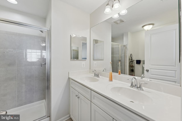 bathroom featuring vanity and a shower with door