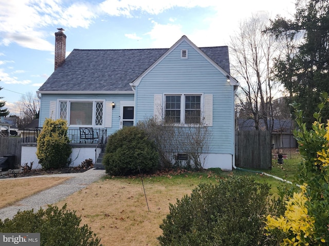 bungalow-style home with a front yard