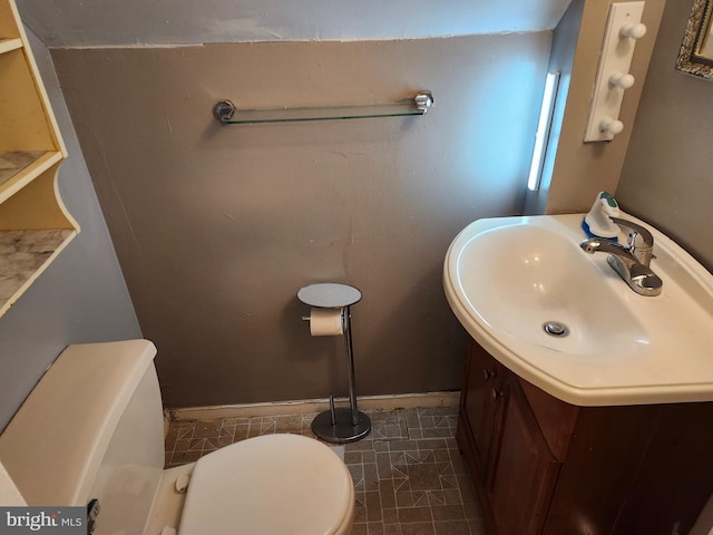 bathroom featuring tile patterned flooring, vanity, and toilet