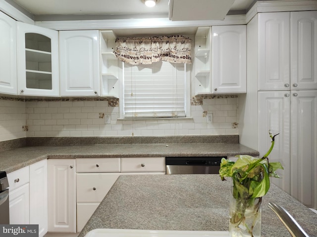 kitchen with decorative backsplash, white cabinetry, and stainless steel dishwasher