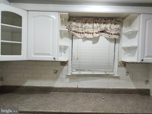 interior space with white cabinets and decorative backsplash