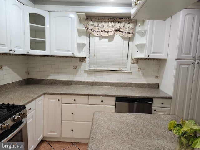 kitchen featuring white cabinets, appliances with stainless steel finishes, tasteful backsplash, and light tile patterned flooring