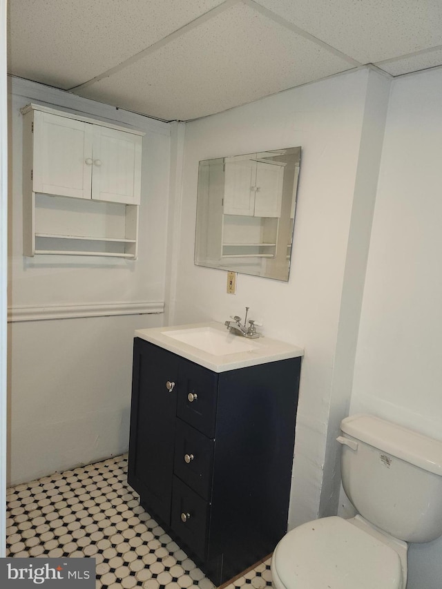 bathroom with vanity, a paneled ceiling, and toilet