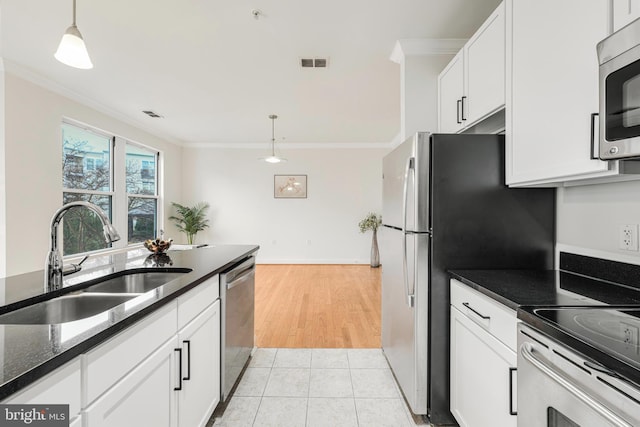 kitchen with white cabinets, crown molding, sink, hanging light fixtures, and stainless steel appliances