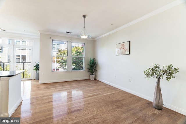 interior space featuring light hardwood / wood-style floors and ornamental molding