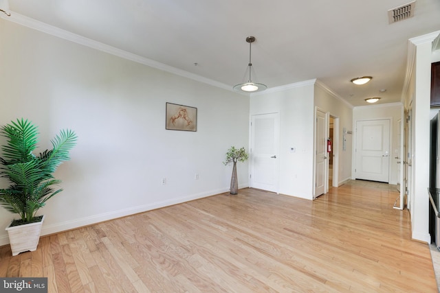 unfurnished room featuring crown molding and light hardwood / wood-style flooring