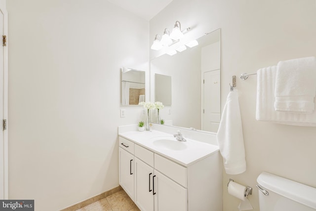 bathroom featuring tile patterned floors, vanity, and toilet