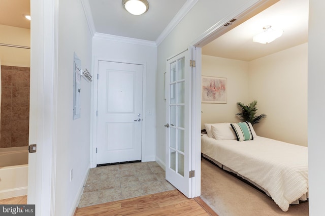 bedroom featuring light wood-type flooring and ornamental molding