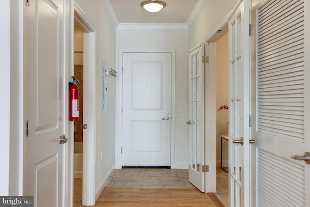 corridor featuring light hardwood / wood-style floors and ornamental molding