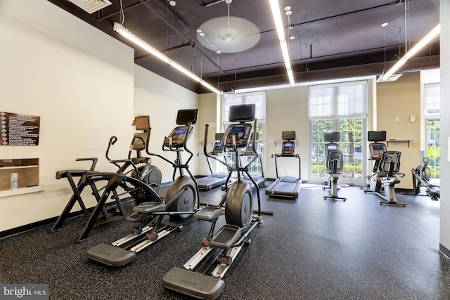 gym with a towering ceiling