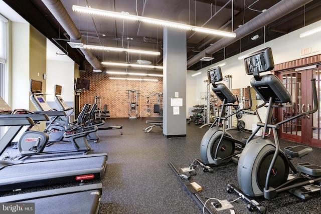 exercise room with brick wall