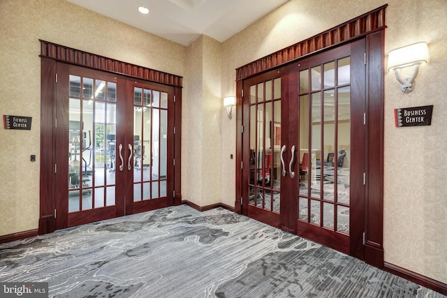 carpeted entryway featuring french doors