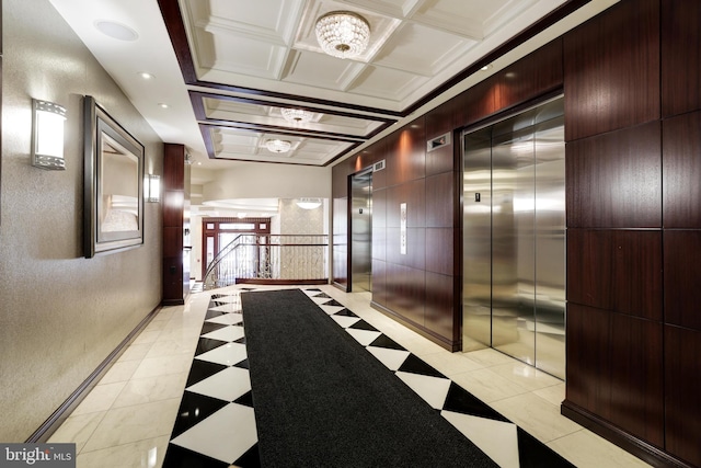 hallway with light tile patterned floors, ornamental molding, elevator, and coffered ceiling