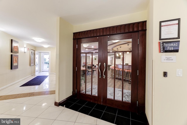 entryway with tile patterned flooring and french doors