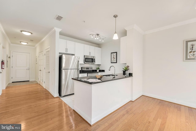 kitchen featuring sink, hanging light fixtures, stainless steel appliances, kitchen peninsula, and white cabinets