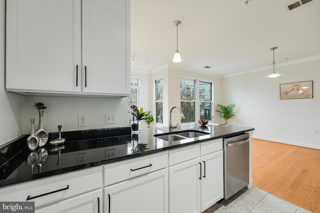 kitchen featuring white cabinets, pendant lighting, stainless steel dishwasher, and sink