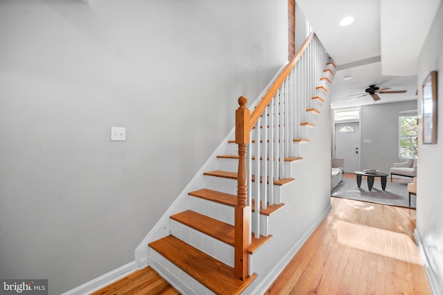 staircase featuring ceiling fan, recessed lighting, wood finished floors, and baseboards