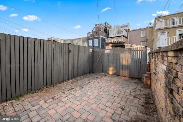 view of patio with a gate and fence