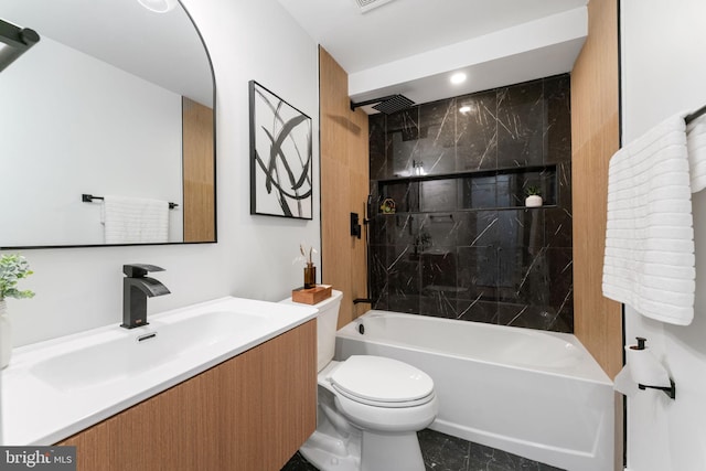 full bathroom with toilet, vanity, and tiled shower / bath