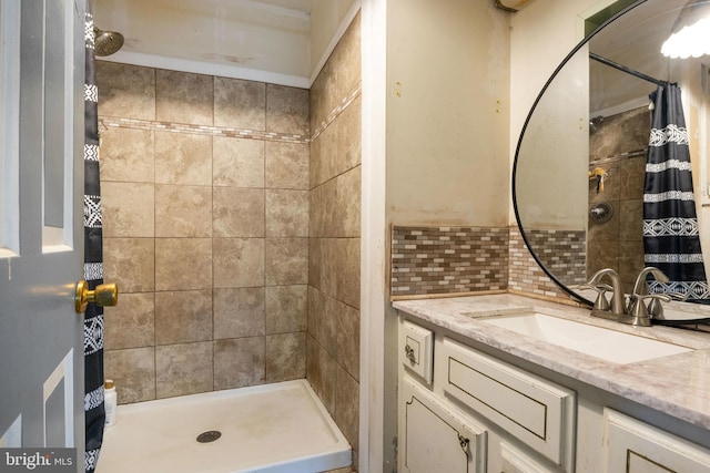 bathroom featuring vanity, backsplash, and walk in shower