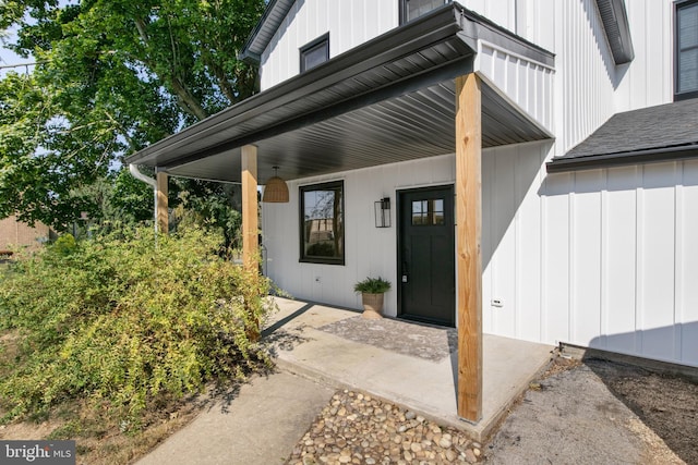 view of exterior entry with covered porch