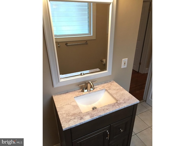 bathroom featuring tile patterned flooring and vanity