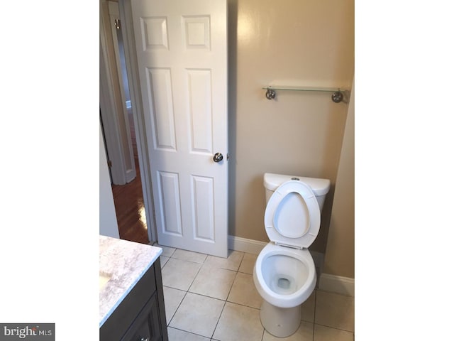 bathroom featuring tile patterned flooring, vanity, and toilet