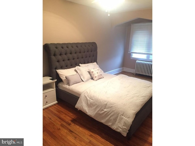 bedroom featuring radiator and dark wood-type flooring