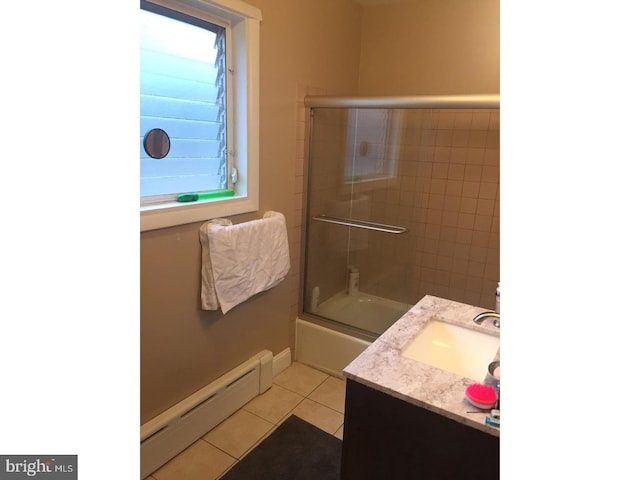 bathroom with baseboard heating, a wealth of natural light, tile patterned floors, and bath / shower combo with glass door