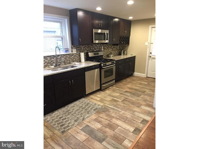 kitchen featuring tasteful backsplash, sink, and stainless steel appliances