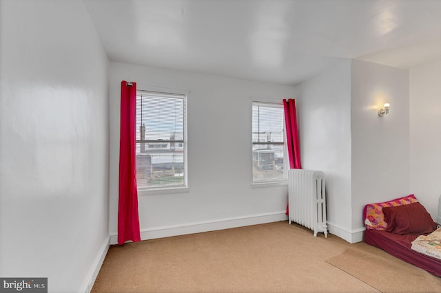 sitting room featuring carpet and radiator heating unit