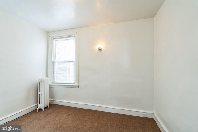 carpeted empty room with radiator heating unit