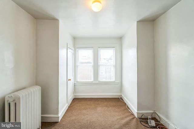 carpeted spare room with radiator