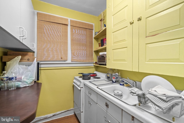 kitchen featuring white range with electric cooktop and sink