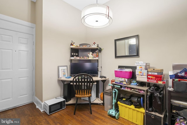 home office with dark hardwood / wood-style flooring