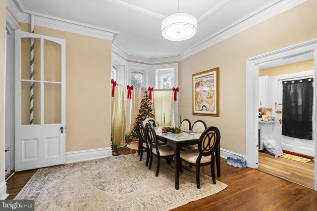 dining area featuring hardwood / wood-style floors and ornamental molding